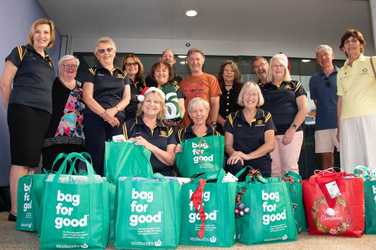 a group of people with bags of food.