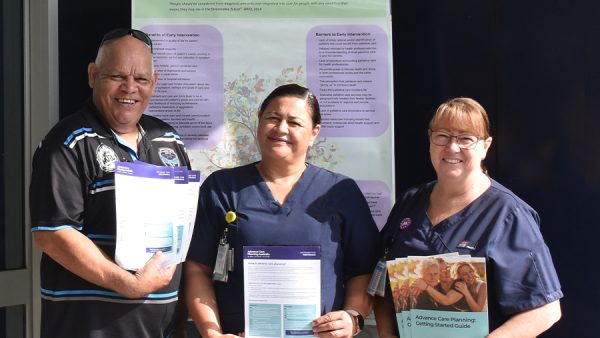 Three healthcare workers with information about advance care planning.