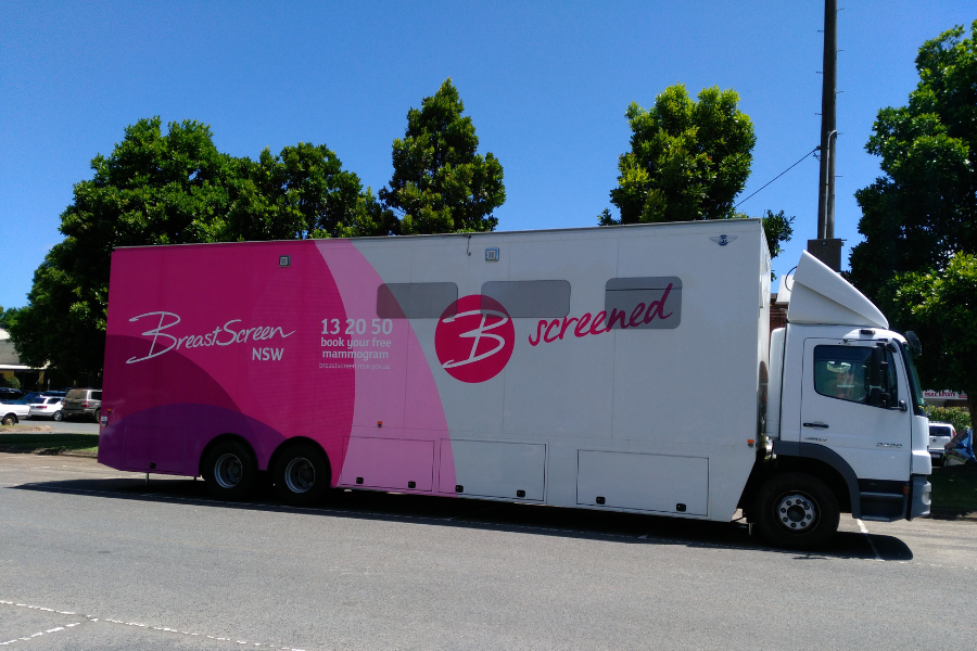 Pink and white mobile cancer screening truck