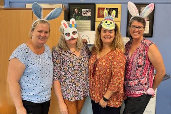 four women wearing Easter bunny ears