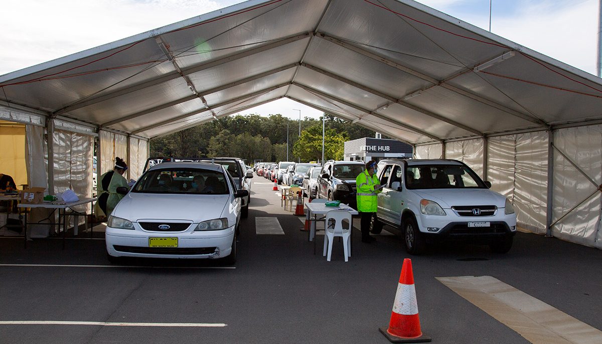 cars lined up at drive-through COVID-19 testing clinic