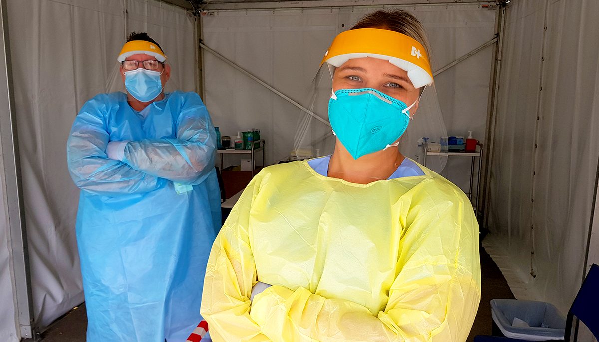 Two health staff wearing personal protective equipment