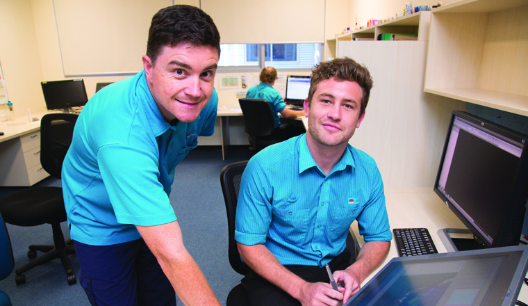 Two Radiation Therapists reviewing patient test results