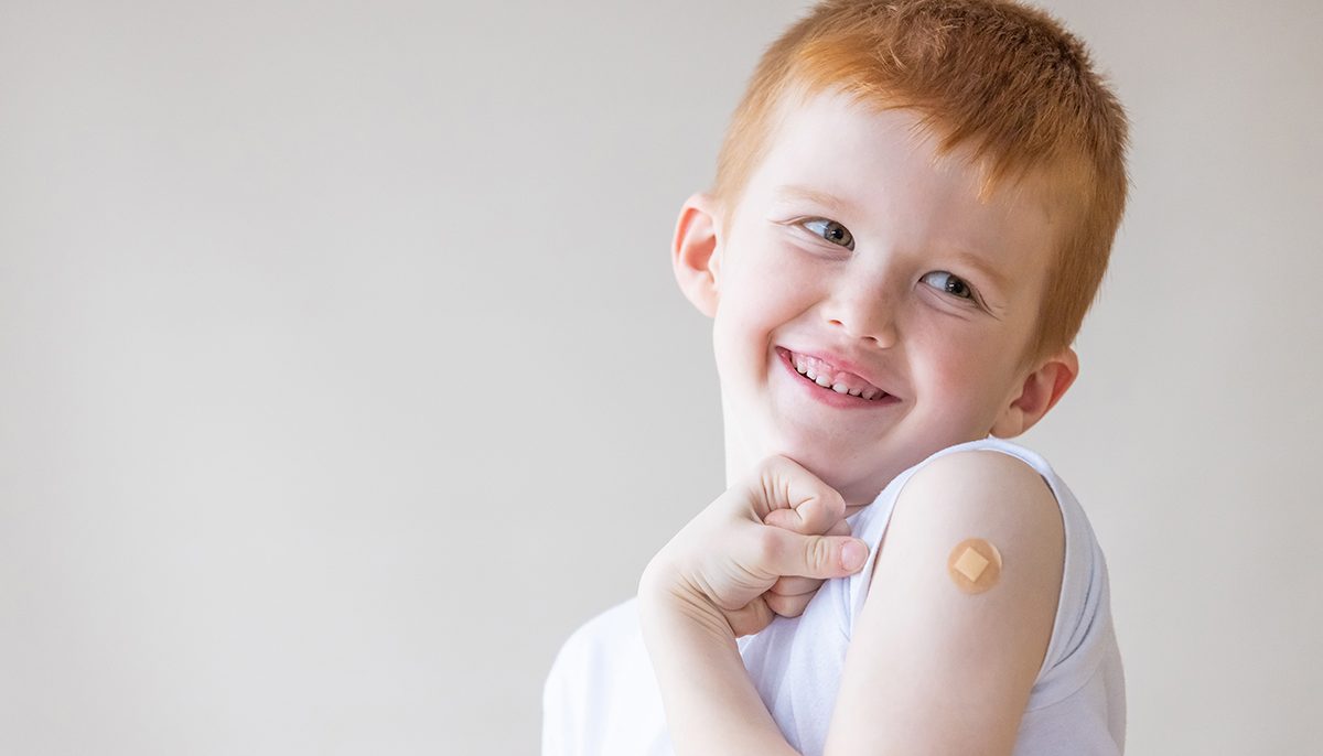 Child with Band-Aid on arm after vaccination