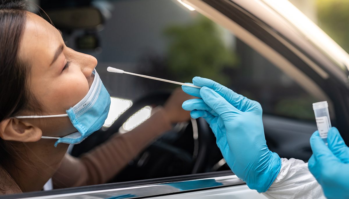 Image of woman being swabbed at drive-through clinic