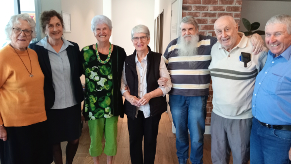 A group of patients and nurses at a social gathering.