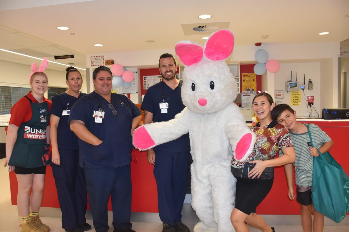 nursing and medical staff standing with a giant Easter bunny.