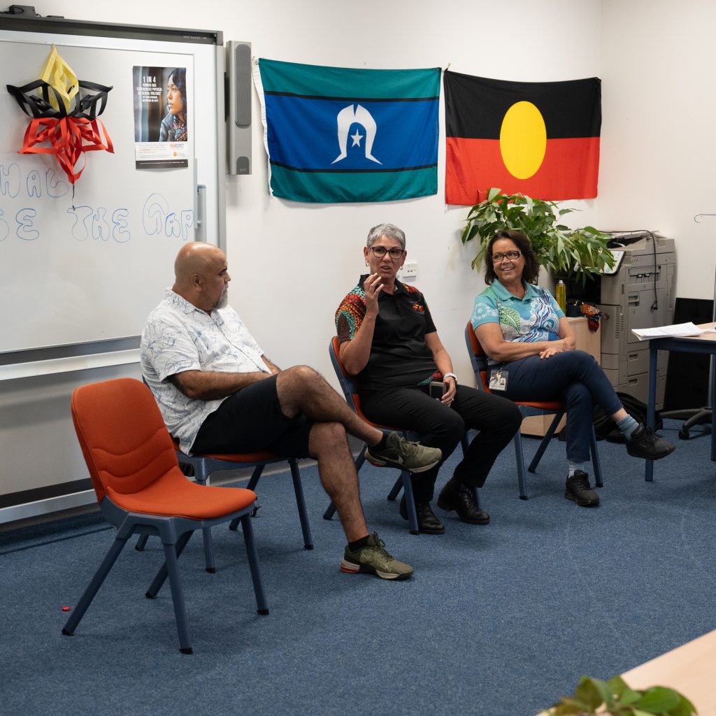 Three Aboriginal health workers in a discussion, yarning