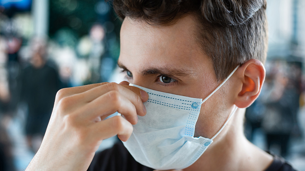 Man fitting a face mask