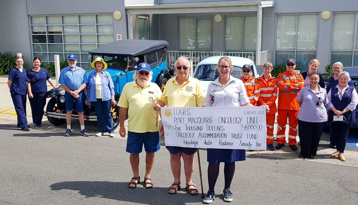 three people with a large cheque for $6000