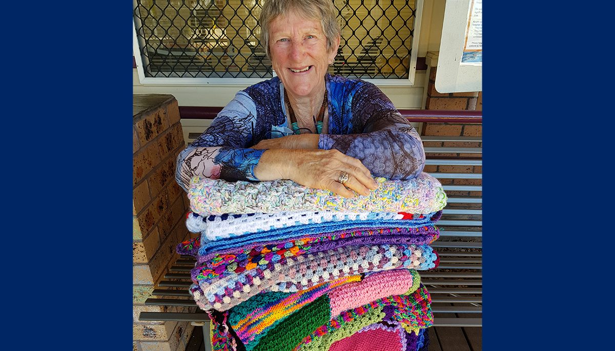 woman with knitted blankets