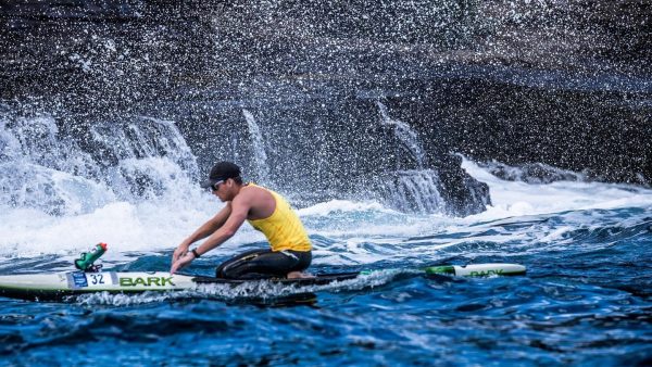 A man paddling a surf ski in the ocean