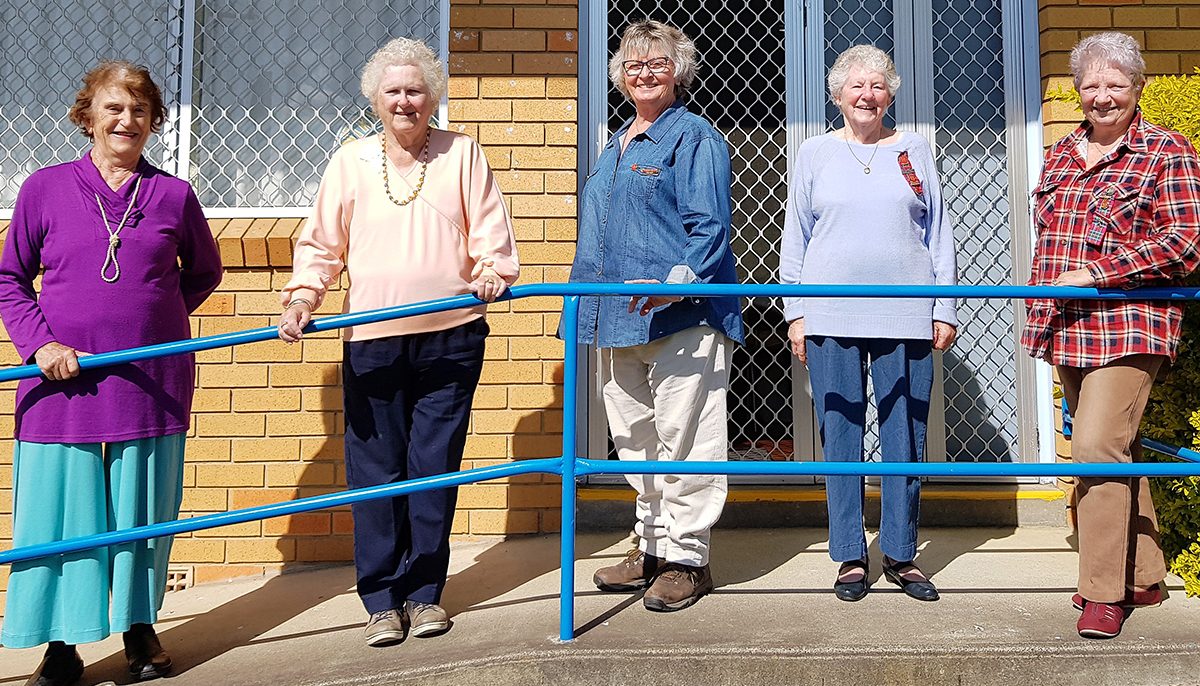 five women standing along a ramp