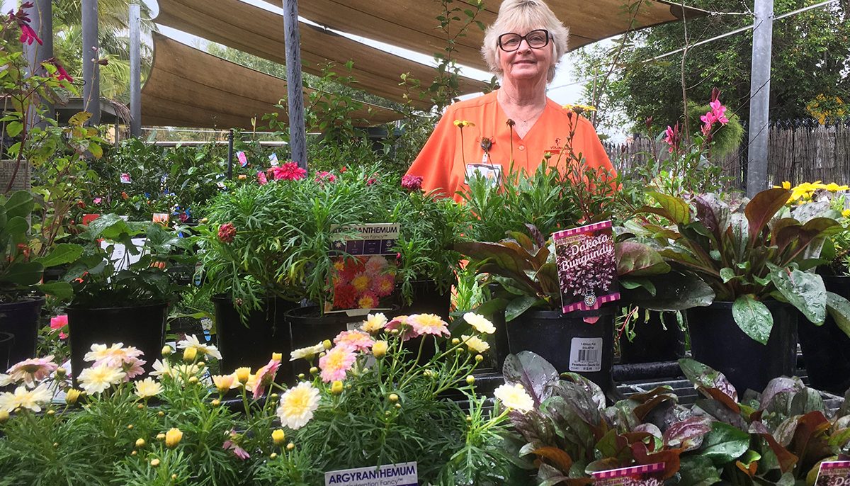 woman standing among plants