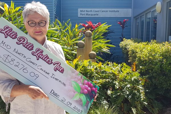 A woman with a large cheque.