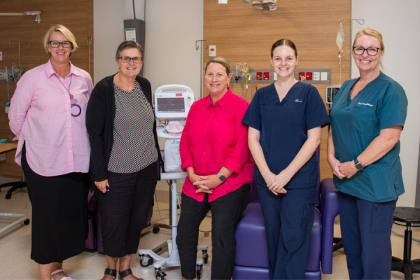 Five healthcare workers in a new cancer service room.