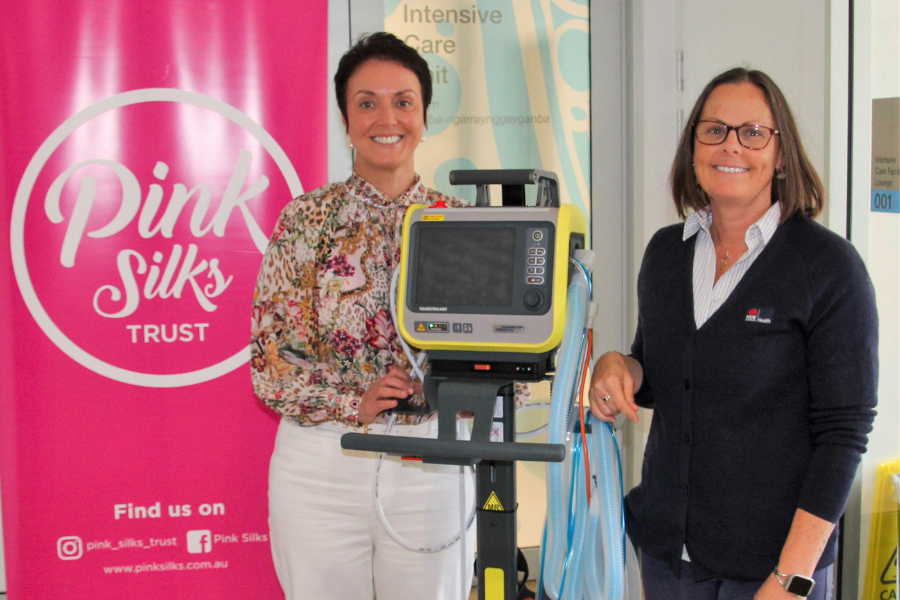 Two women with a ventilator.