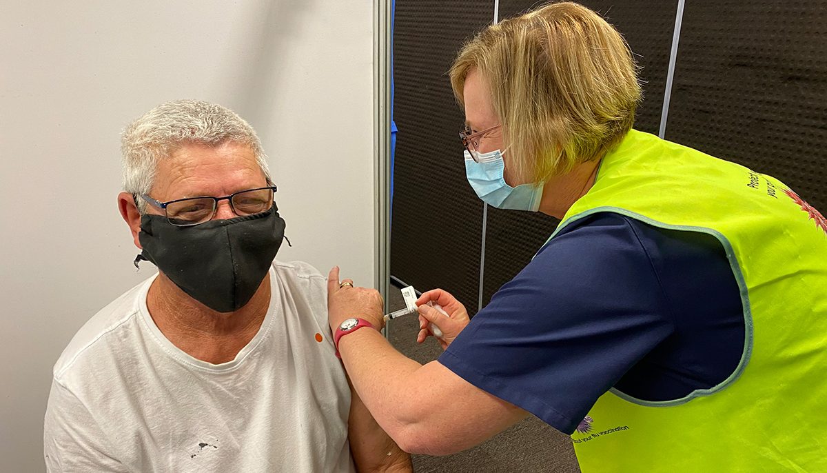 nurse vaccinating a man