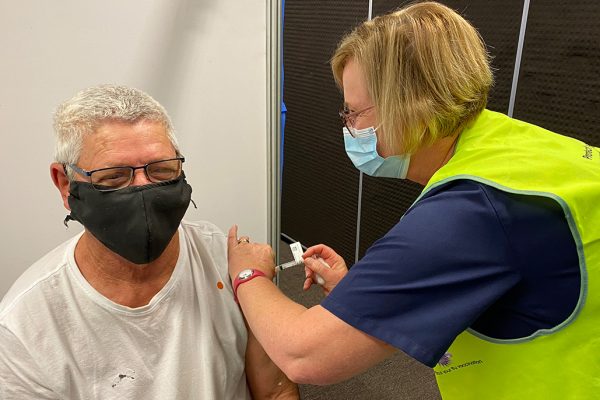 nurse vaccinating a man