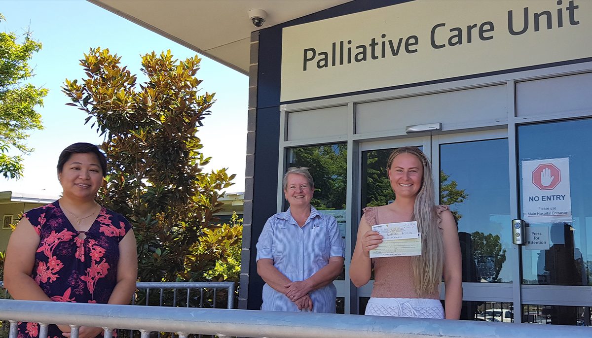 Three women standing at the entrance to a palliative care unit