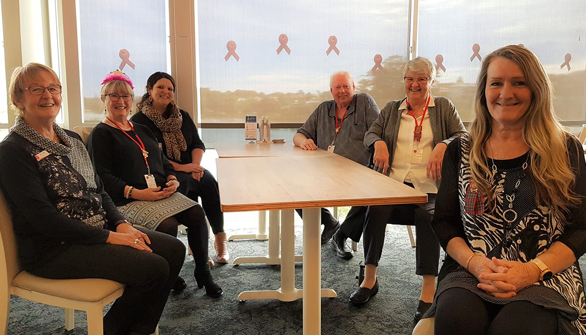 six people sitting at a table