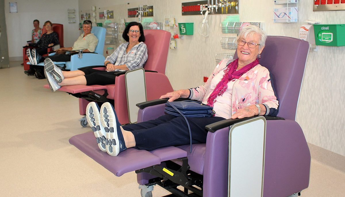 Four women sitting in recliner chairs