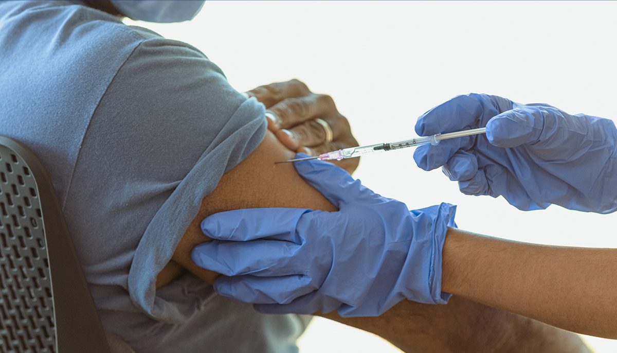 vaccine needle in a person's arm