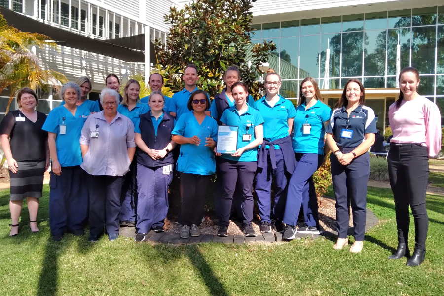 A group of physiotherapists with an award.