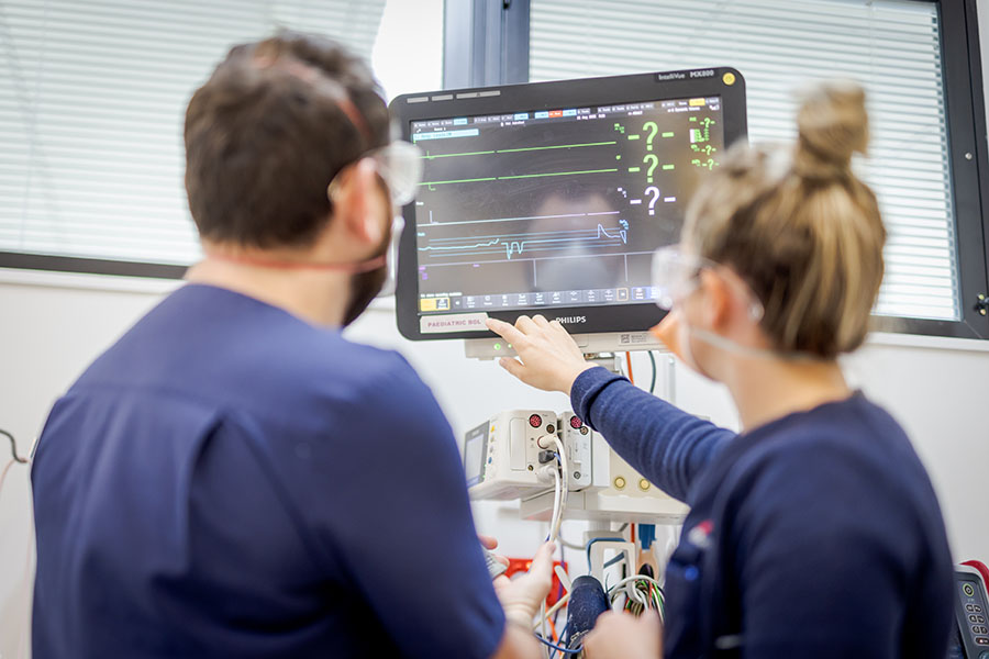 two nurses looking at a monitor