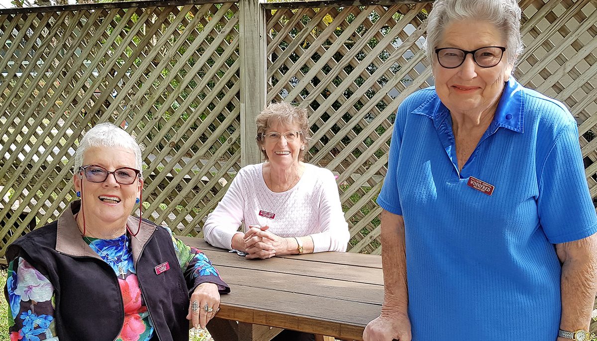 Three women at an outdoor table