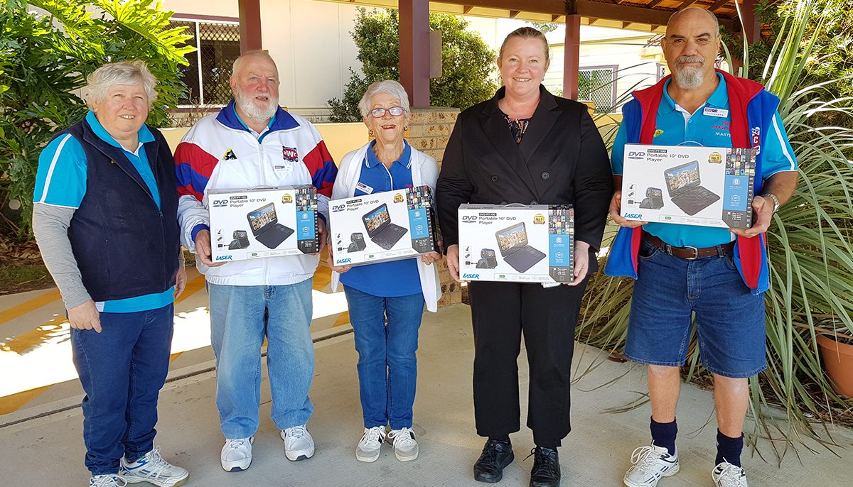 four bowlers with a nurse holding portable DVDs