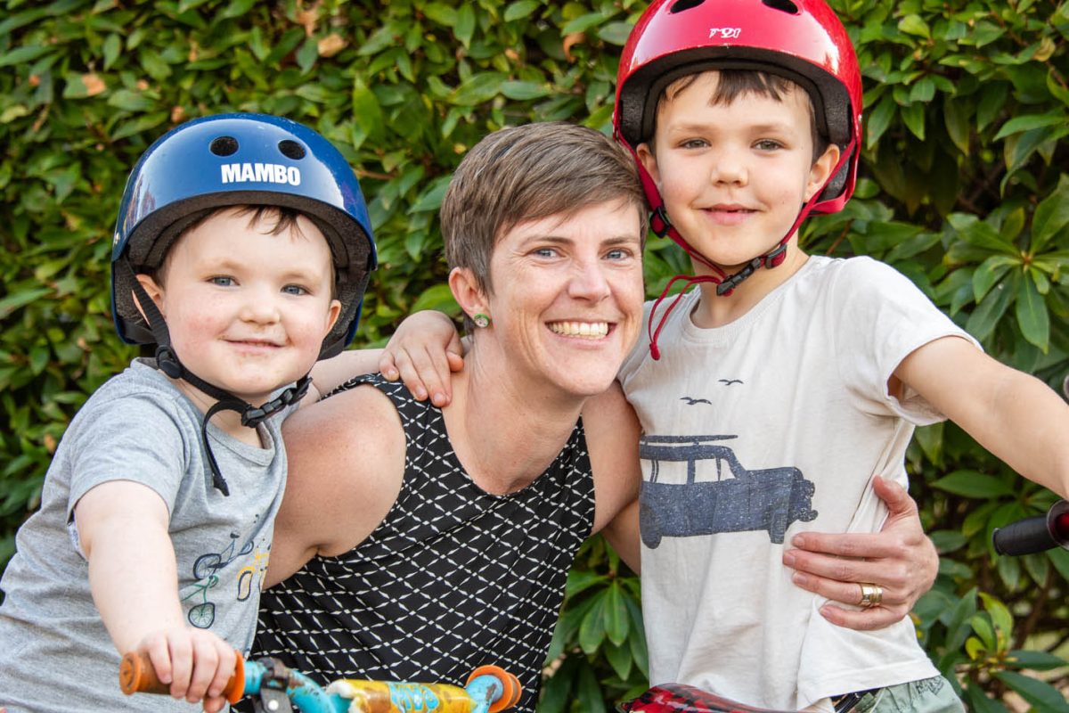 Two boys on bikes with their mum